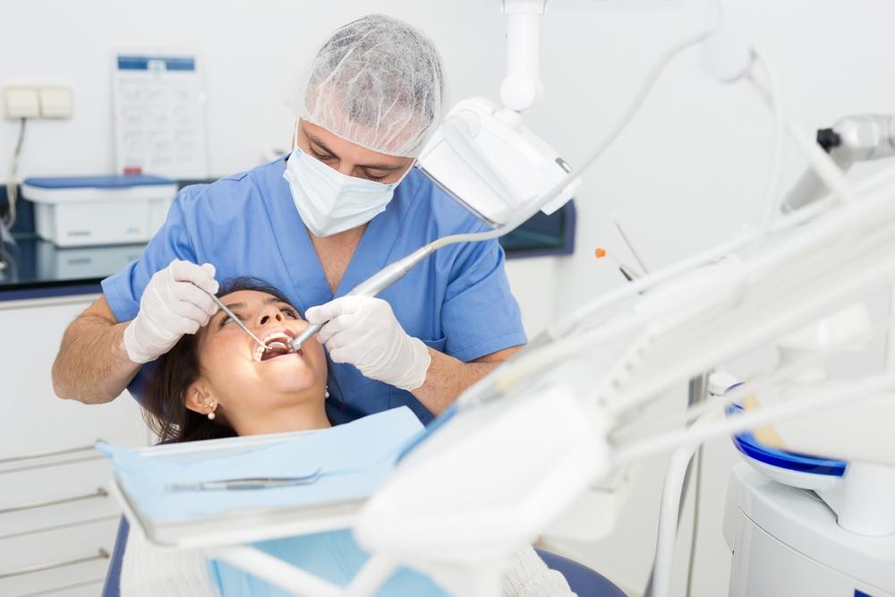 Dentist performing cosmetic dentistry procedure
