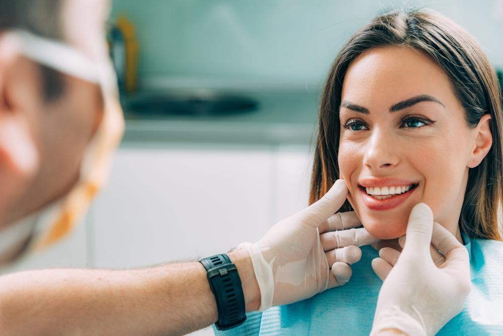 Dentist assessing the transformative outcome of cosmetic dentistry
